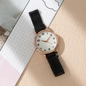 Detail of rose gold quartz watch with black mesh strap and white dial numbering