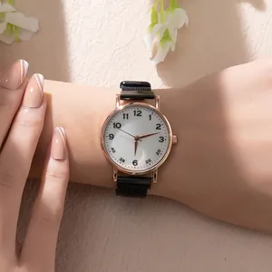 Detailed close-up of rose gold watch with white dial and black magnetic mesh strap