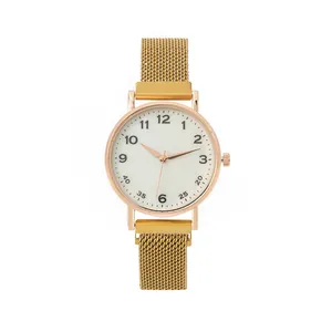 Detail of elegant gold Milanese mesh strap and white dial with Arabic numerals