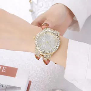 Close-up of luxury gold ladies watch with crystal encrusted dial and roman numerals
