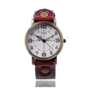 Macro shot of industrial retro quartz watch with wide burgundy leather strap and bronze case