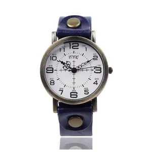 Macro detail of retro quartz watch with navy leather strap and bronze metal case