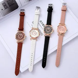 Detailed overhead view of four minimalist quartz watches with diamond heart dials in various colors