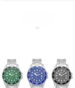 Detailed view of three quartz watches with green blue and black dials on silver steel bands