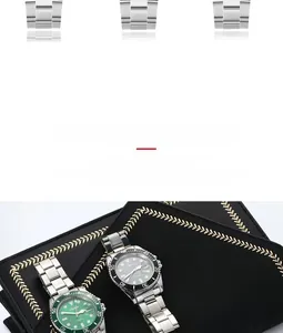 Detail view of steel strap and diver style watches with green and black calendar dials