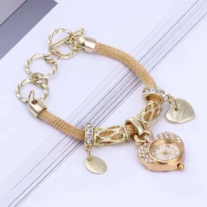 Luxury gold heart-shaped watch with crystal bezel and charm bracelets for women