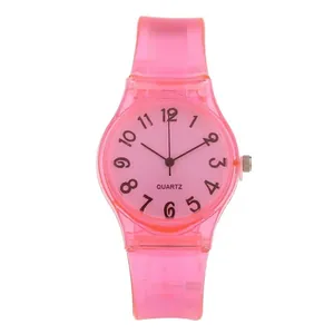 Close-up of pink translucent jelly watch featuring clear black Arabic numerals and quartz dial