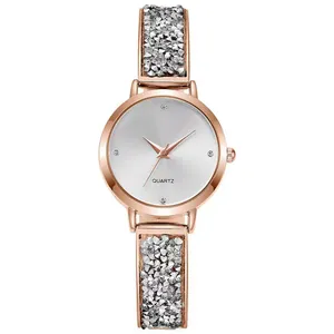 Detailed macro of rose gold quartz watch featuring a crystal-encrusted bracelet and dial
