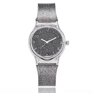 Detail of silver glitter silicone strap and clear resin case on starry sky quartz watch