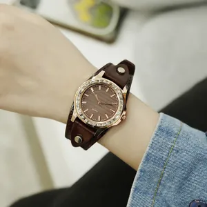 Women's quartz watch with rose gold crystal bezel and brown wide leather cuff strap