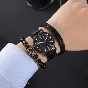 Detail of men's black leather watch set with woven bracelet and tiger eye stone bead