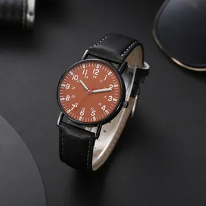 Close-up of quartz watch with brown dial, Arabic numerals, and black stitched leather strap