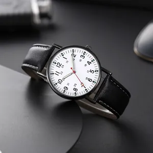 Detail of a minimalist men's watch with double-scale white dial and black leather strap