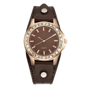 Women's quartz watch with rose gold crystal bezel and wide brown studded leather cuff strap