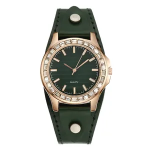Detailed macro view of green quartz watch dial with rose gold case and crystal bezel