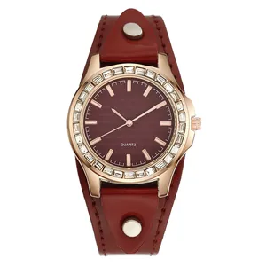 Macro detail of wine red wave texture dial and sparkling crystal bezel quartz watch