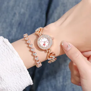 Rose gold heart watch and bracelet set with rhinestones on a denim background