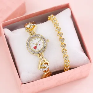 Elegant gold heart bracelet watch set with crystals in a pink gift box display