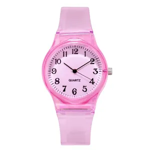 Pink translucent quartz watch for women with numeric dial and silicone strap on white background