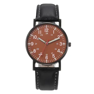 Vintage luminous watch with brown dial, black leather strap and contrast stitching