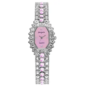 Detailed macro view of an octagonal pink dial watch with silver rhinestones