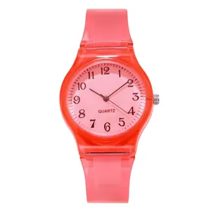 Pink translucent quartz watch with jelly silicone strap and numeric dial on white background