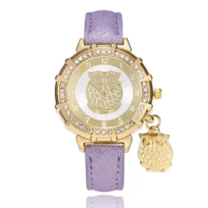 Gold owl watch with purple glitter strap and crystal bezel, featuring a matching owl pendant