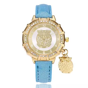Gold owl pendant watch with crystal bezel and sparkling blue leather strap for women