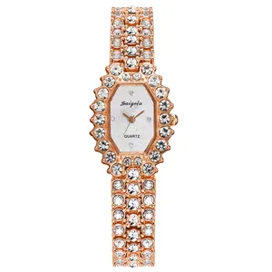 Detail of rose gold octagonal watch dial with quartz movement and sparkling rhinestones