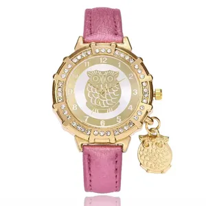 Detail of pink glitter leather strap watch with gold owl pendant and crystal bezel
