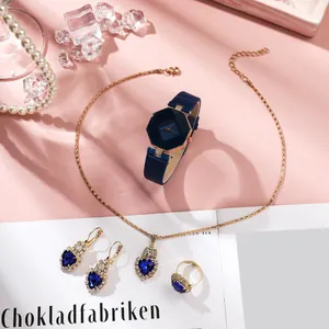 Women's quartz watch set with heart-shaped blue gems and gold necklace earrings