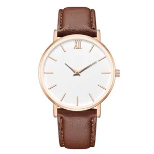 Macro view of brown leather strap with fine stitching and rose gold quartz watch case