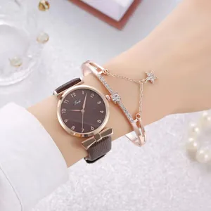 Close-up of elegant rose gold watch with brown leather strap and matching star bracelet