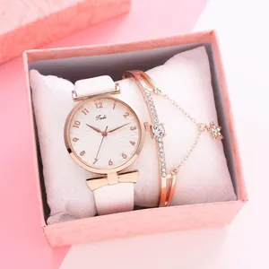 Close-up of rose gold ladies watch and star bracelet set in a pink gift box