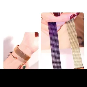 Close-up of magnetic Milanese mesh watch strap in gold and purple steel texture