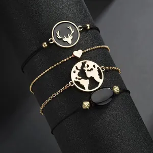 Chic 4-piece black and gold bracelet set featuring heart, map charms, and deer silhouette