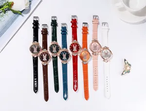 Flat lay of colorful women's quartz watches with sparkling rabbit dials and leather bands