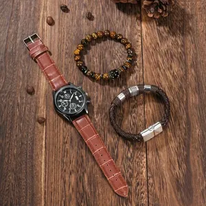 Men's quartz watch with brown leather strap and beaded bracelets on dark wood