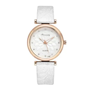 Detailed macro view of white embossed texture watch strap and rose gold quartz dial