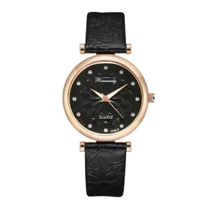 Detail of rose gold watch with black floral embossed leather strap and faceted dial