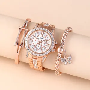 Close-up of rose gold watch set with crystal-encrusted bezel and matching bracelets