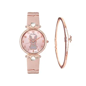Detail of pink leather watch with rabbit motif dial and rose gold star charm bracelet