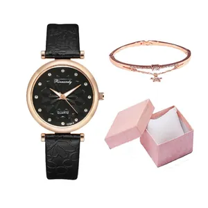 Close-up of black leather strap watch with rhinestone markers and starry dial in a gift box