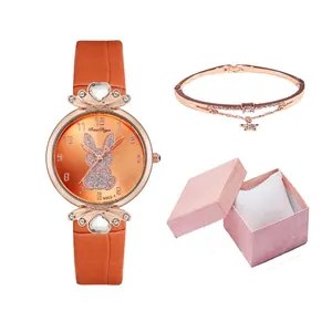 Close-up of rabbit pattern watch dial with rose gold bracelet in pink gift box