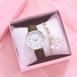 Women's quartz watch with brown leather strap and floral charm bracelet in a gift box
