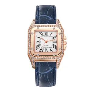 Detail of rose gold square quartz watch with crystal bezel and blue leather strap