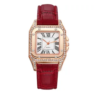 Detail of rose gold square quartz watch with red leather strap and crystal bezel