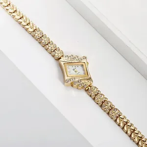 Women's gold diamond rhombic watch with leaf-shaped chain strap on white display