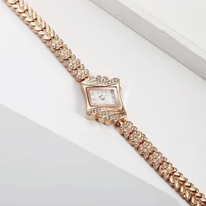 Detailed close-up of rose gold leaf-shaped watch band and diamond-encrusted bezel