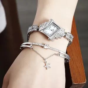 Elegant silver rhombic dial watch with star pendant bracelet set worn on wrist